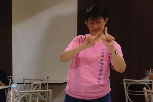 woman using Thai Sign Language